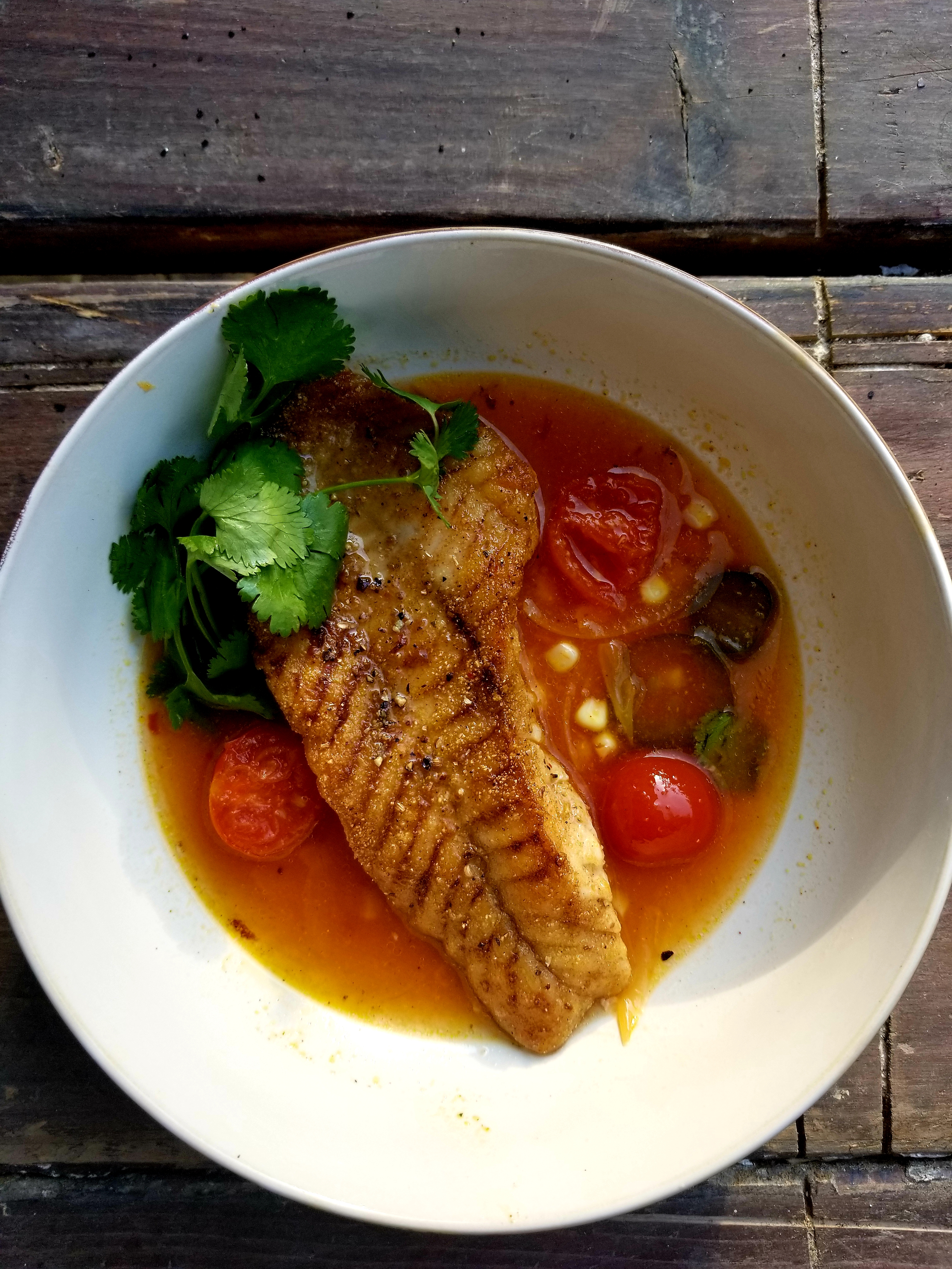 Lightly coated snapper in a spicy tomato broth
