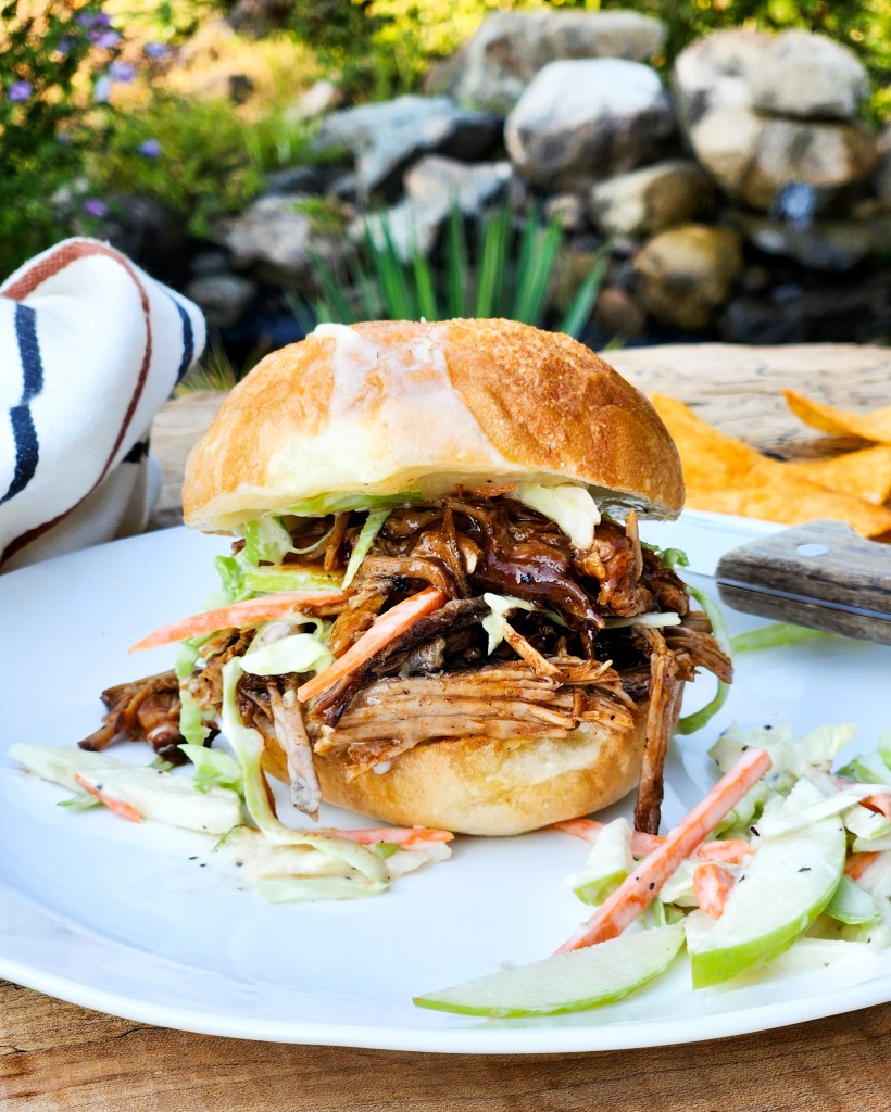 Coca-Cola Pulled Pork Sliders are rich and tangy with creamy apple carrot slaw on a white cheddar toasted slider bun.