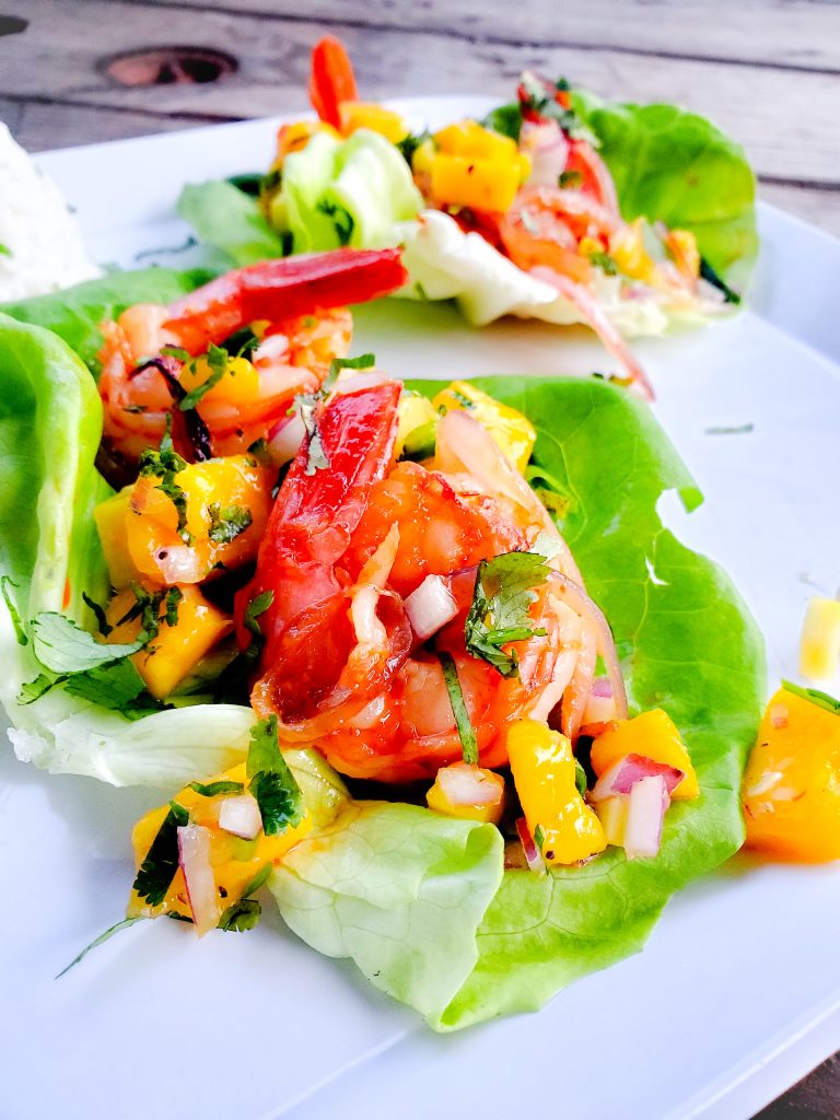 Bite size lettuce wraps with mango chile shrimp and mango salsa