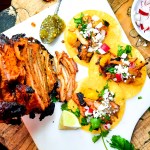 Cantina style Tacos al Pastor are marinated, grilled on the rotisserie and shaved off into your corn tortilla with bits of charred pineapple.