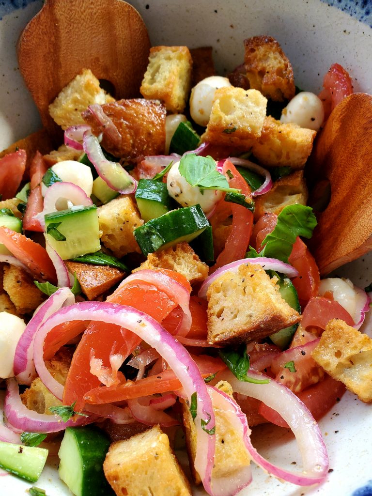 Panzanella Salad is the perfect summer dinner salad. Vine ripe tomatoes, fresh basil and crusty French bread accompany fresh mozzarella, cucumber and red onions with vinaigrette.