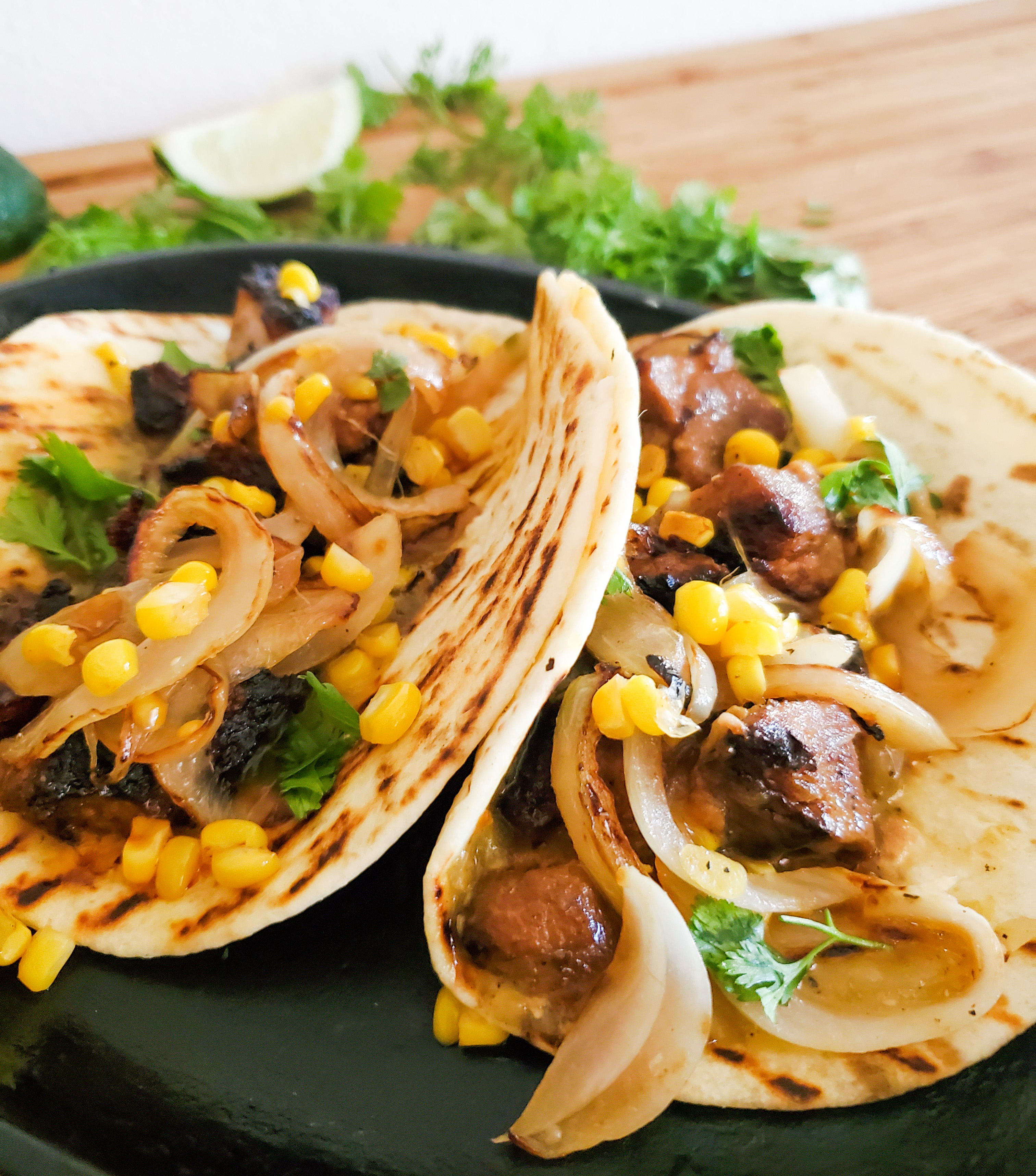 Tender pork gets crisped and served in a charred flour tortilla with corn relish and tomatillo salsa