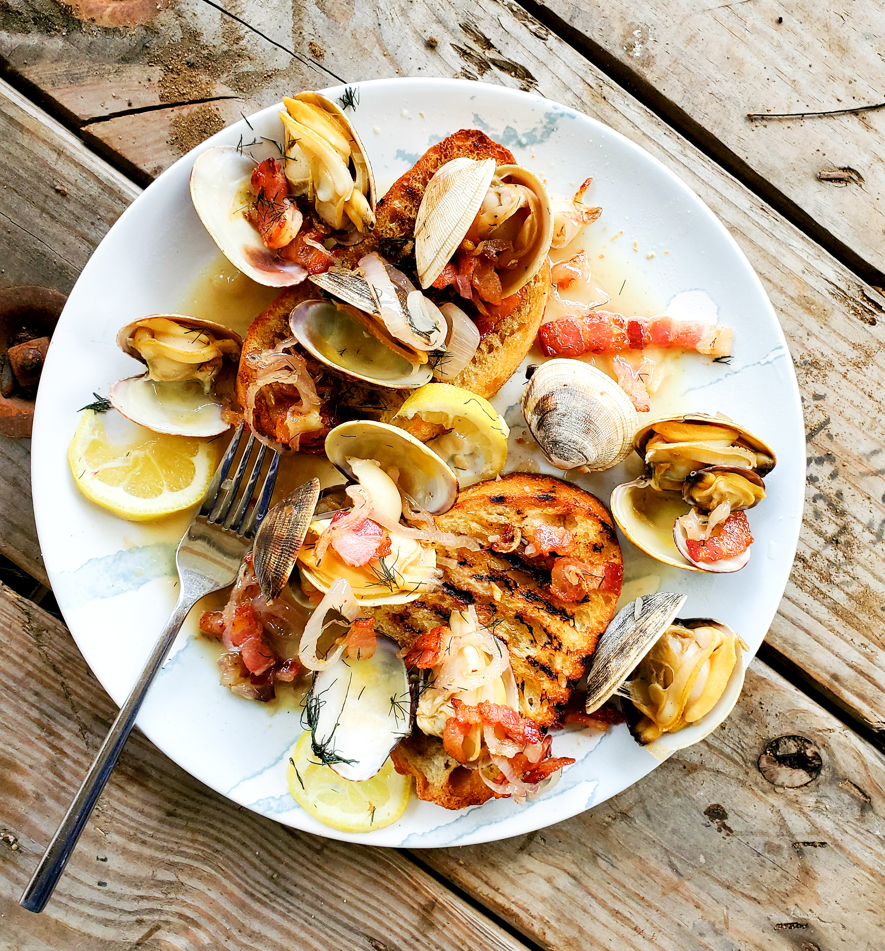 Simple, yet elegant Steamer Clams gently steamed in white wine and fennel with bacon a shallot. A Pacific Northwest favorite served over grilled toast.