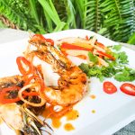 Chili- Garlic Head On Shrimp deliver all the flavor with papaya salad drizzled in hot honey and lime juice and coconut lime rice.