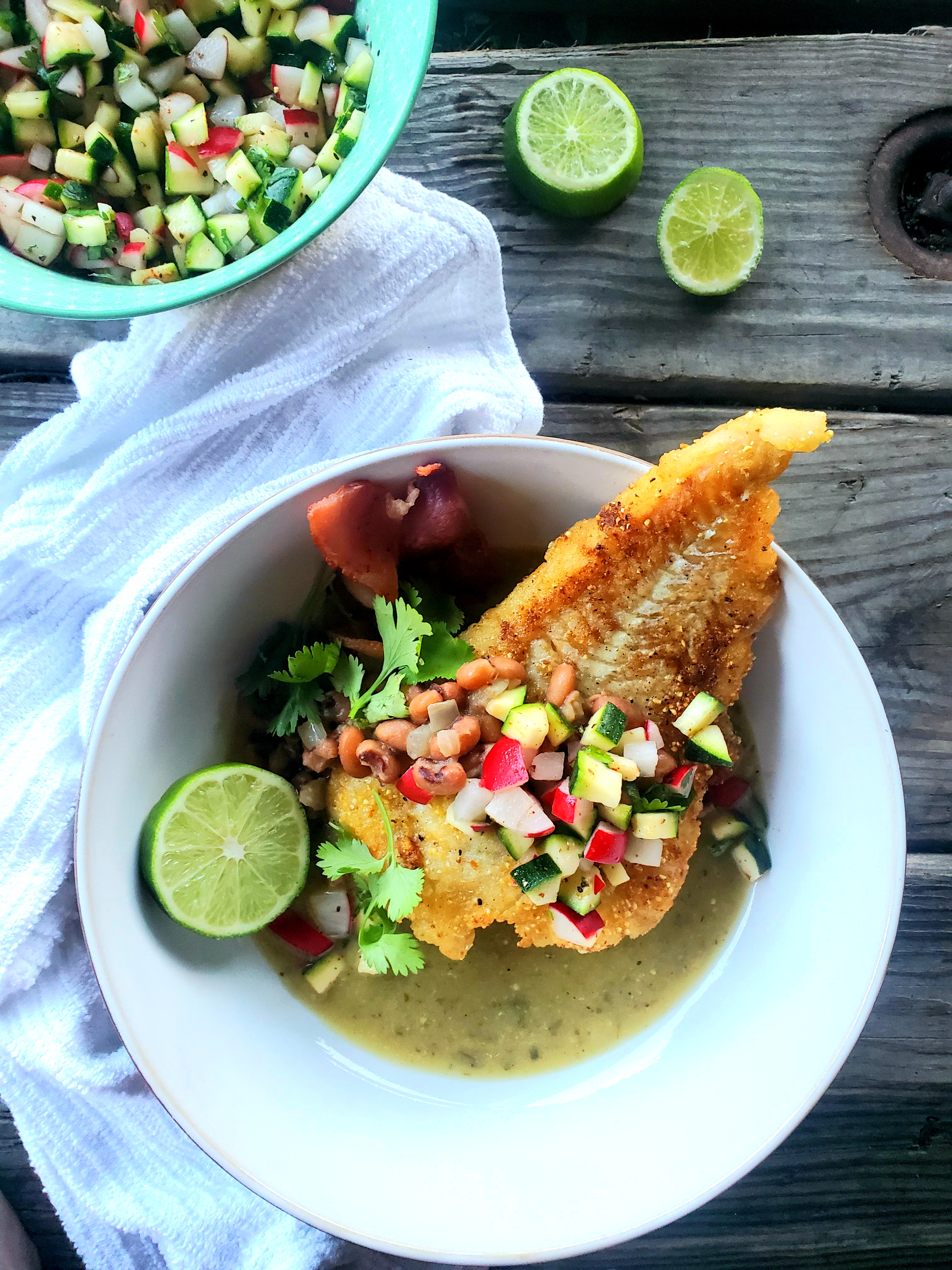 Cod fillet lightly dusted in cornmeal, pan fried with black eyed peas in a tomatillo broth.
