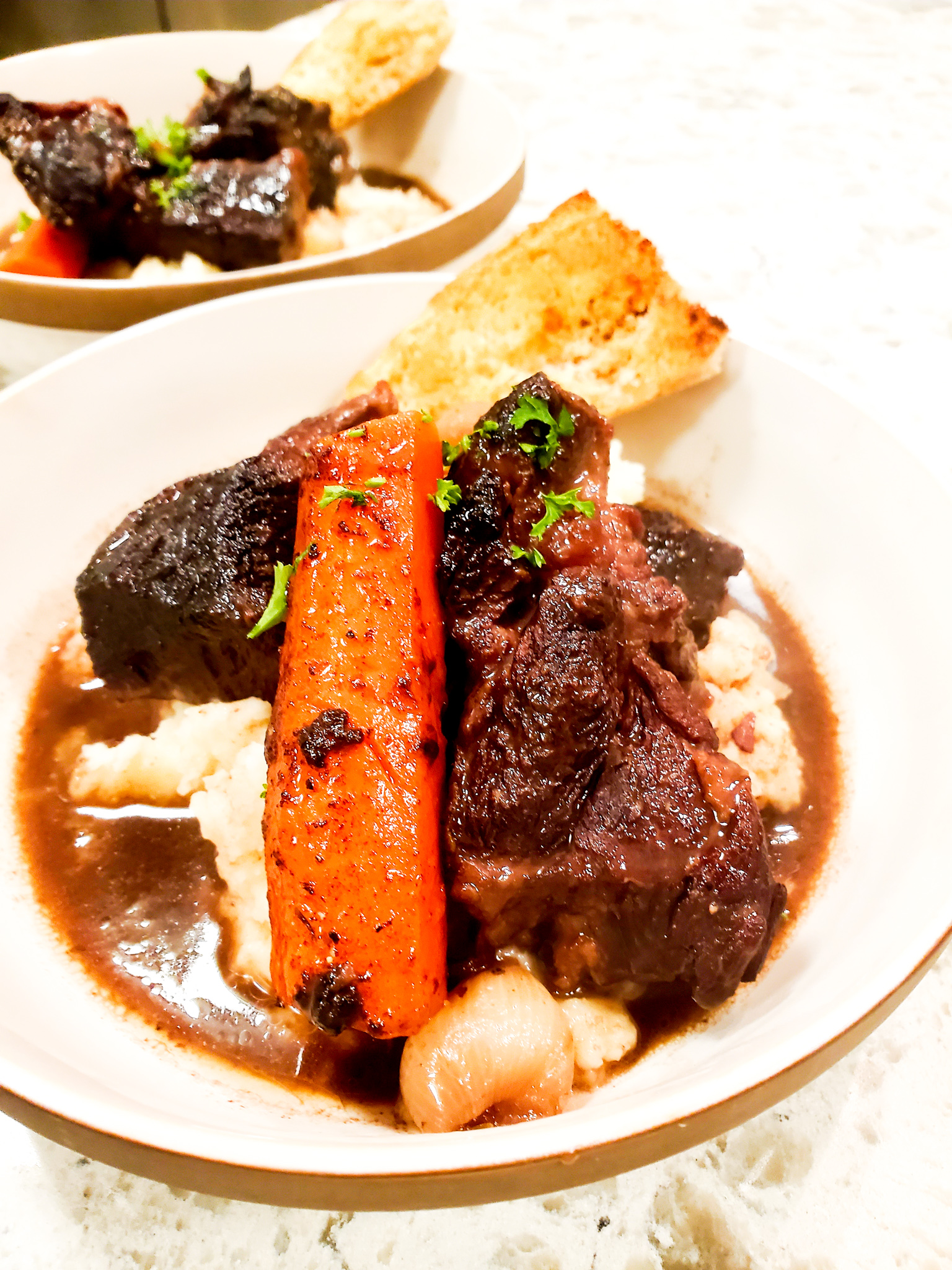 Tender, fall apart, beef chuck braised in rich port wine with carrots and pearl onions over creamy mashed potatoes