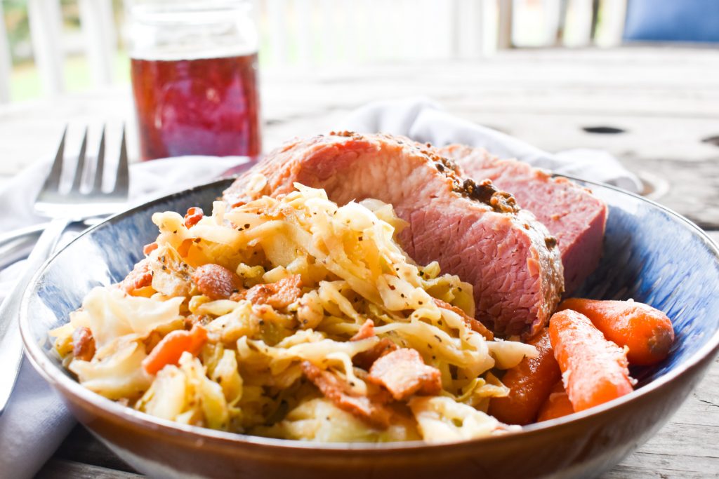 Tender, flavorful oven roasted corned beef with quick cabbage cooked in bacon fat