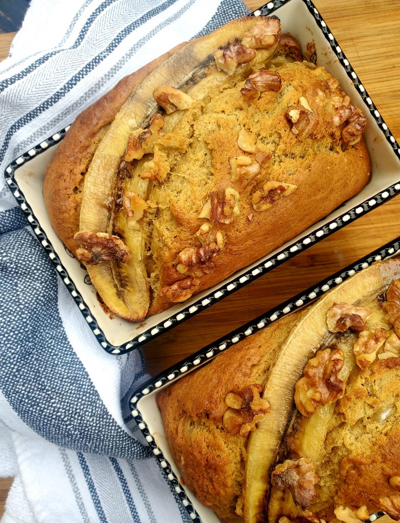 Rustic Banana Bread is a simple recipe made with noticeable pieces of banana, topped with a caramelized slice of banana and toasted walnuts.