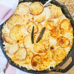 Golden browned red potato gratin with warm and spicy Serrano peppers
