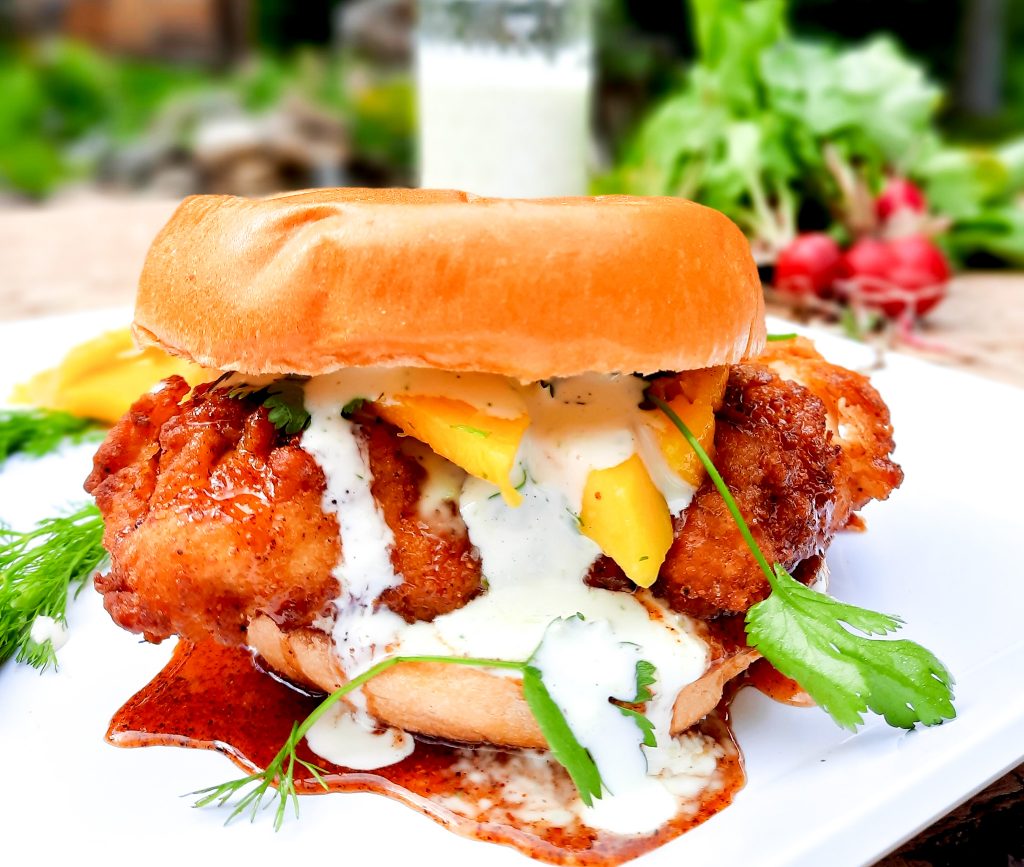 Hot chicken sandwich, creamy jalapeno sauce and fresh mango