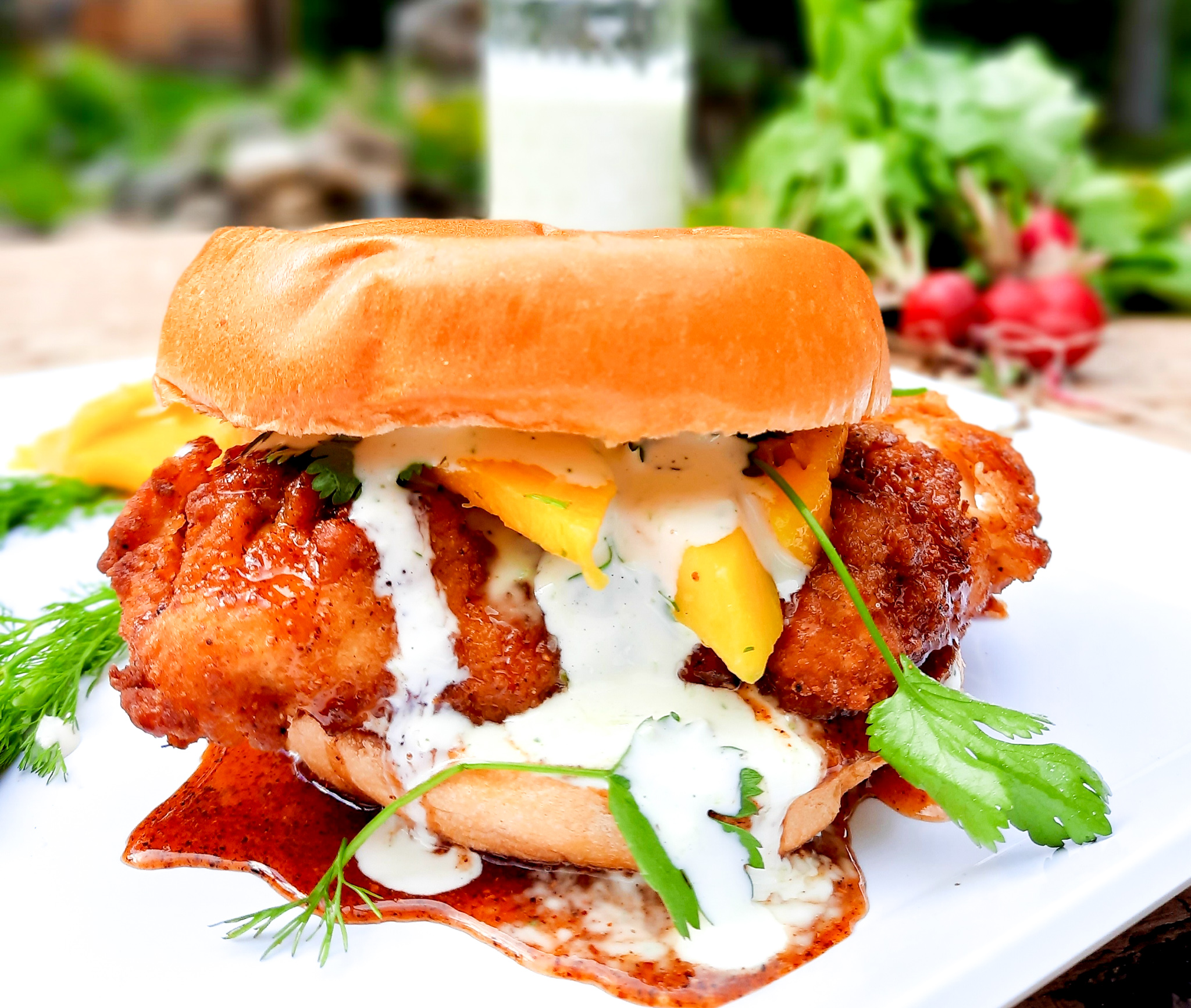 Hot chicken sandwich, creamy jalapeno sauce and fresh mango
