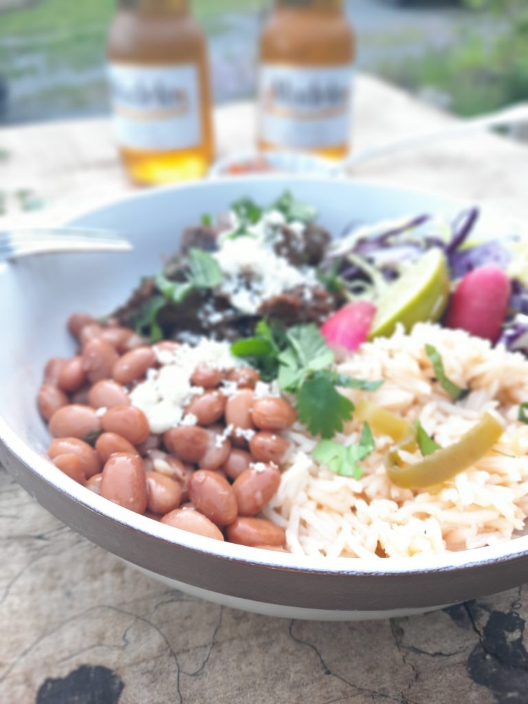Cumin pinto beans and Mexican rice accompany this shredded beef cooked in Guajillo and Pasilla peppers