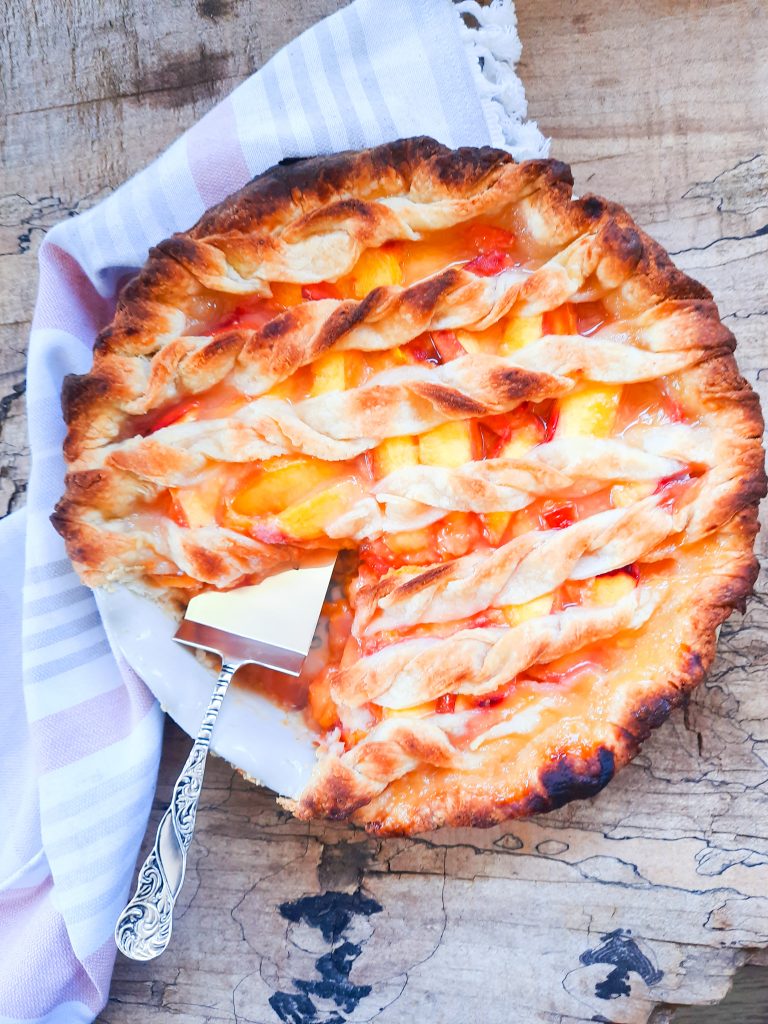 Peaches coated in apple bourbon glaze in all butter pie crust
