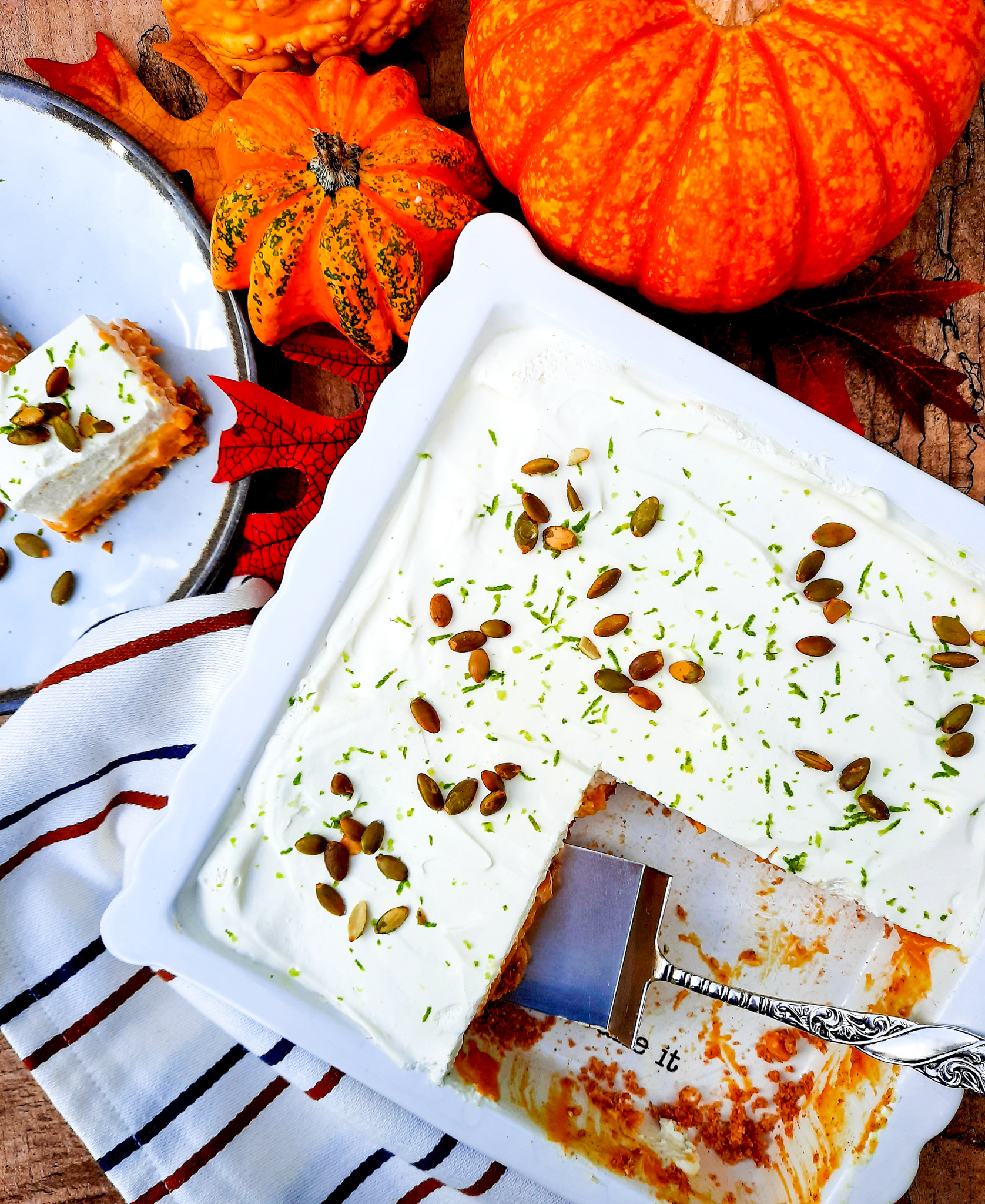 Pumpkin Cream Bars with Chili Lime Pepitas combines the flavors of traditional pumpkin pie with lime zested whipped cream topping and chili lime pepitas in a graham cracker crust.