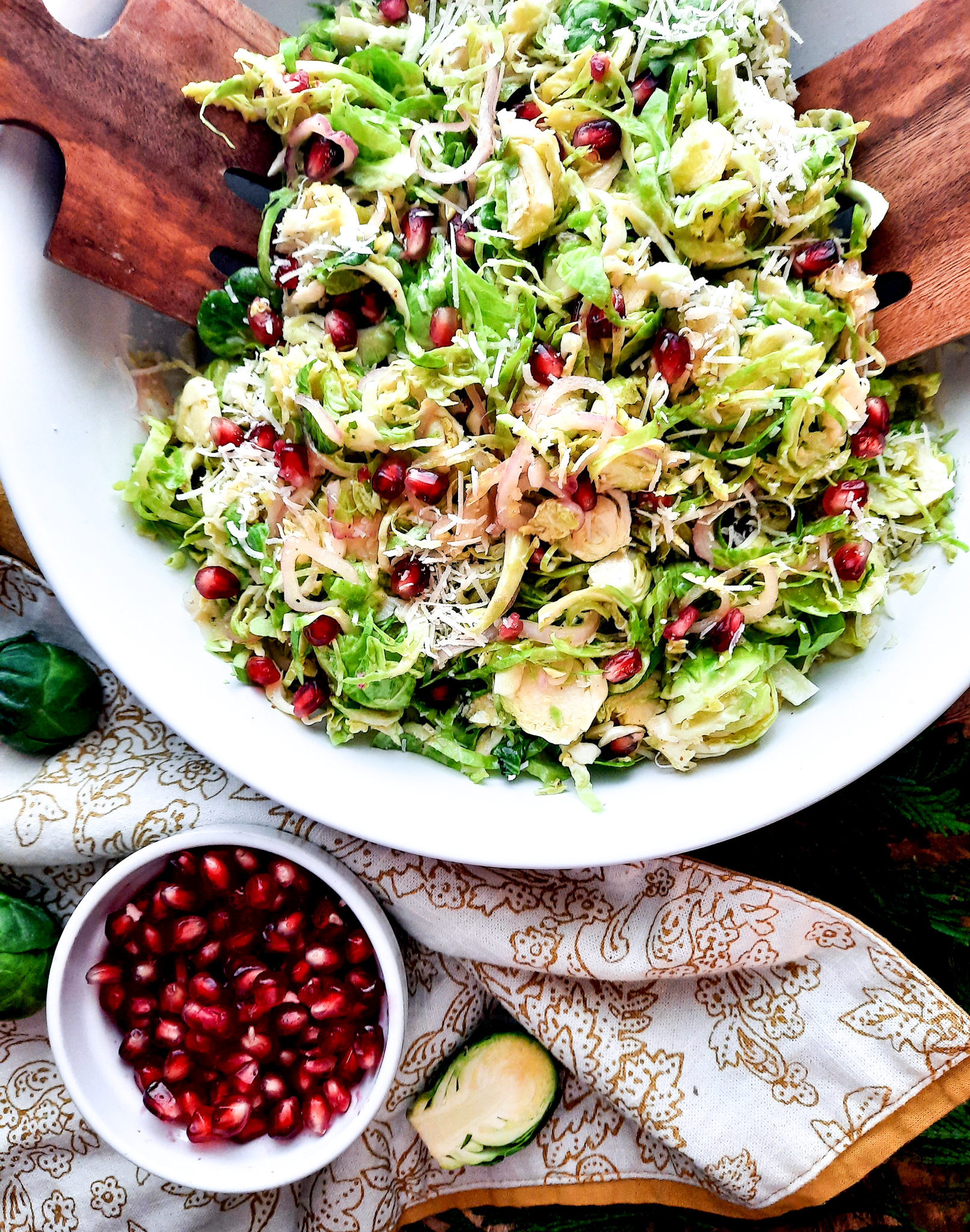 Shallot lemon vinaigrette drizzled over this Shaved Brussels Sprouts Salad with grated parmesan, pomegranate and toasted bread crumbs.