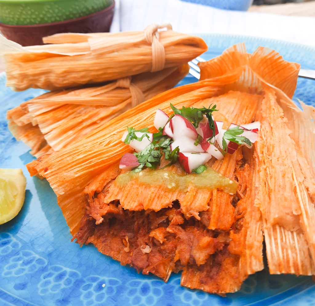 Freshly made Red Chili Tamales are tender and flavorful with diced radish and cilantro