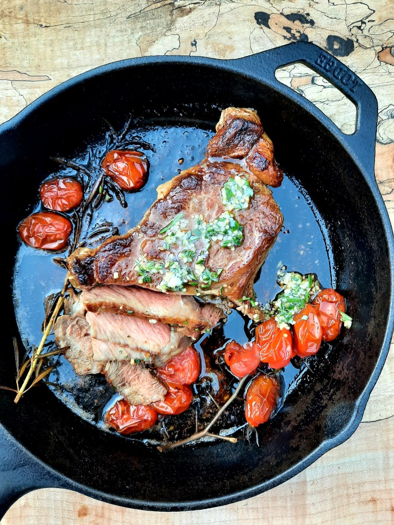 Cast iron seared Rib Steak with Chive Butter and sweet vine tomatoes