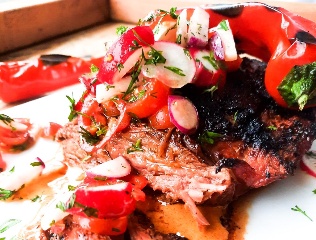 Grilled Bavette Steak with Smoked Paprika Sauce has a spicy seasoned crust and a juicy tender inside with fresh tomato radish salad.
