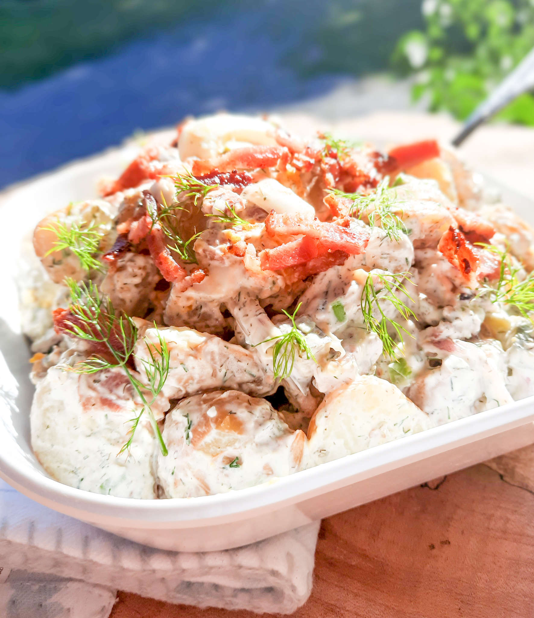 Spicy Dill Pickle Potato Salad with Bacon combines new potatoes with creamy dill dressing, Fresno chilies and my favorite spicy dill pickles.