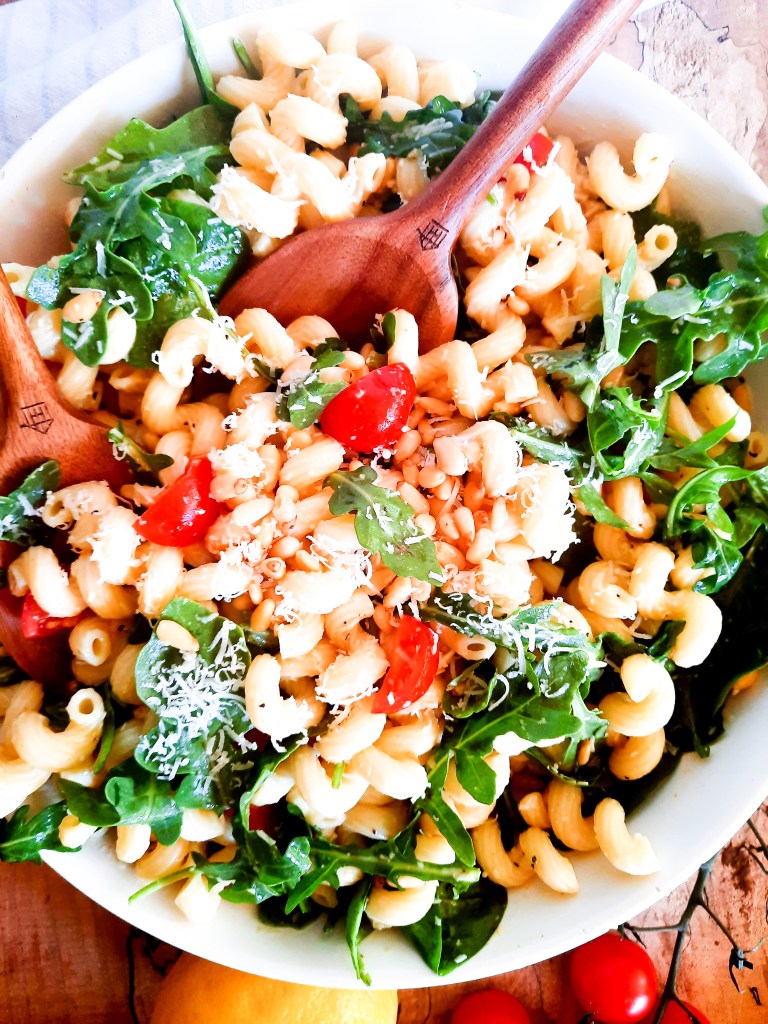 Out West's Lemon Arugula Pasta Salad combines cellentani pasta, arugula, pine nuts and cherry tomatoes in a light lemon vinaigrette dressing.