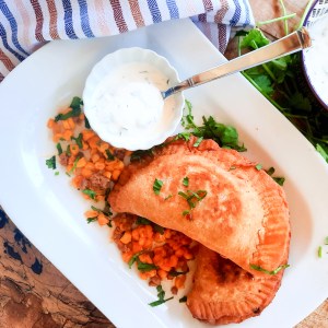 Chorizo-Corn Empanadas are savory hand pies made with a masa harina flour blend and filled with cheese, spicy ground chorizo and sweet corn.