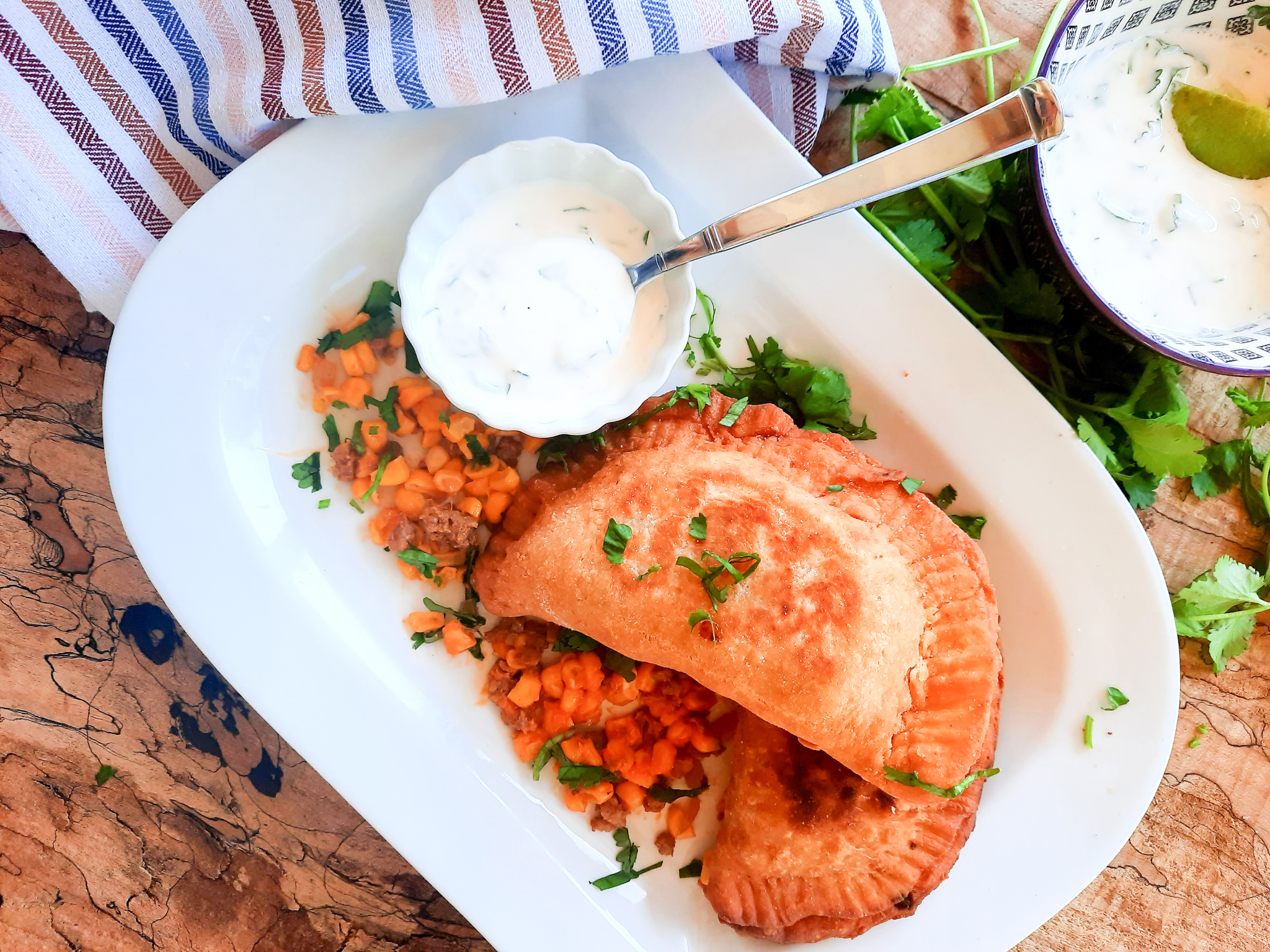 Chorizo-Corn Empanadas are savory hand pies made with a masa harina flour blend and filled with cheese, spicy ground chorizo and sweet corn.