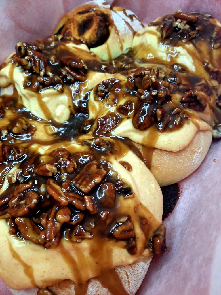 Sticky Pumpkin Pecan Cinnamon Rolls celebrate fall with pumpkin cream cheese frosting and sticky caramel pecan topping.