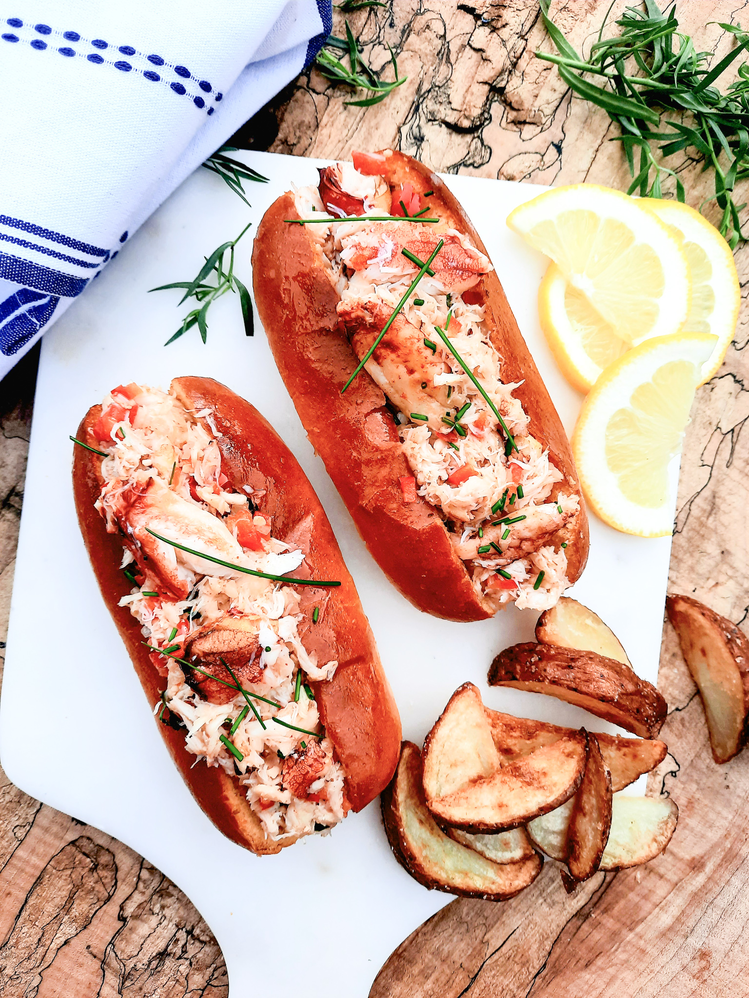 Dungeness Crab Rolls let the crab shine with butter warmed lump pieces, minced red pepper, tarragon, smoky chipotle and a squeeze of lemon.