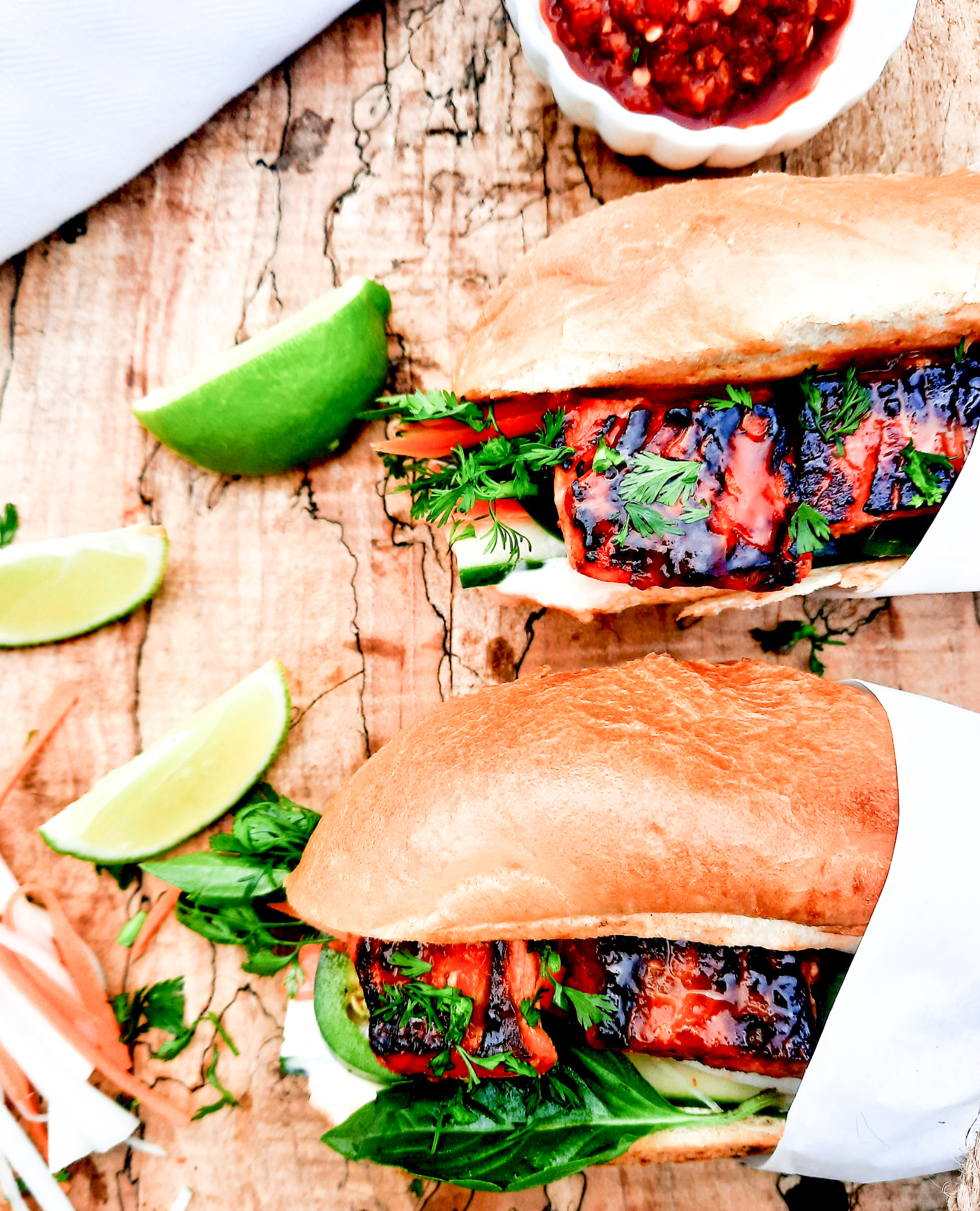 Salmon Bahn Mi Sandwich is a West Coast and Vietnamese fusion with pickled carrot, daikon radish, sriracha mayo and fresh herbs.