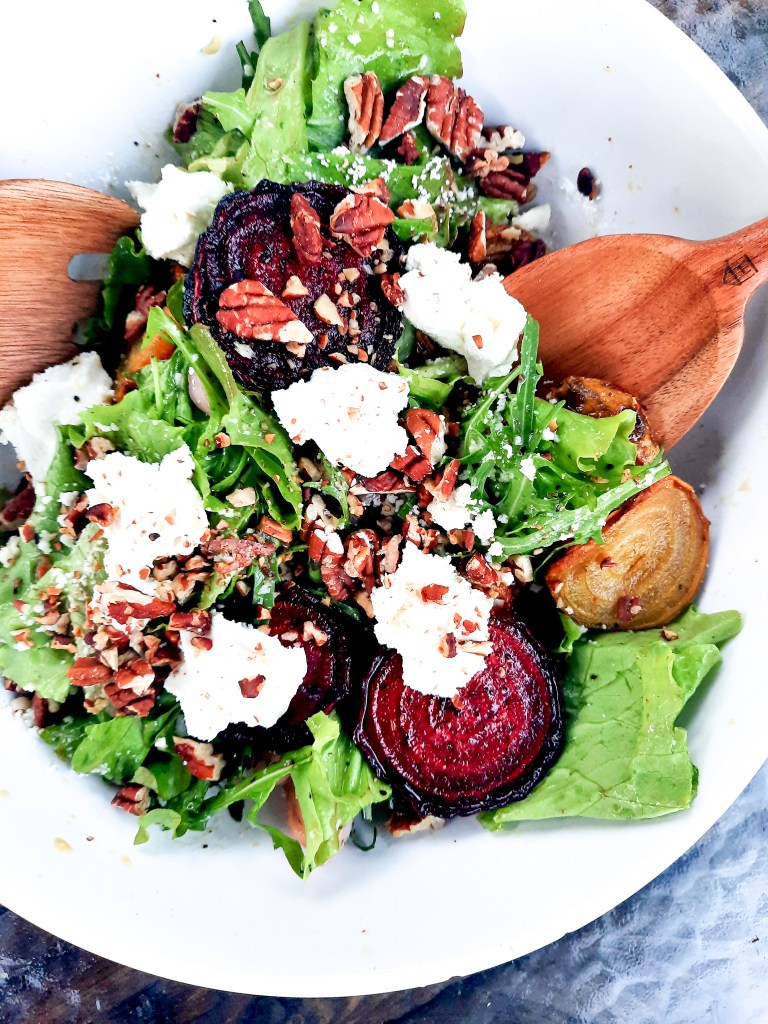 Roasted Beet Salad with Goat Cheese and Pecans combines slices of roasted red and yellow beets with goat cheese, greens and toasted pecans in a shallot vinaigrette.