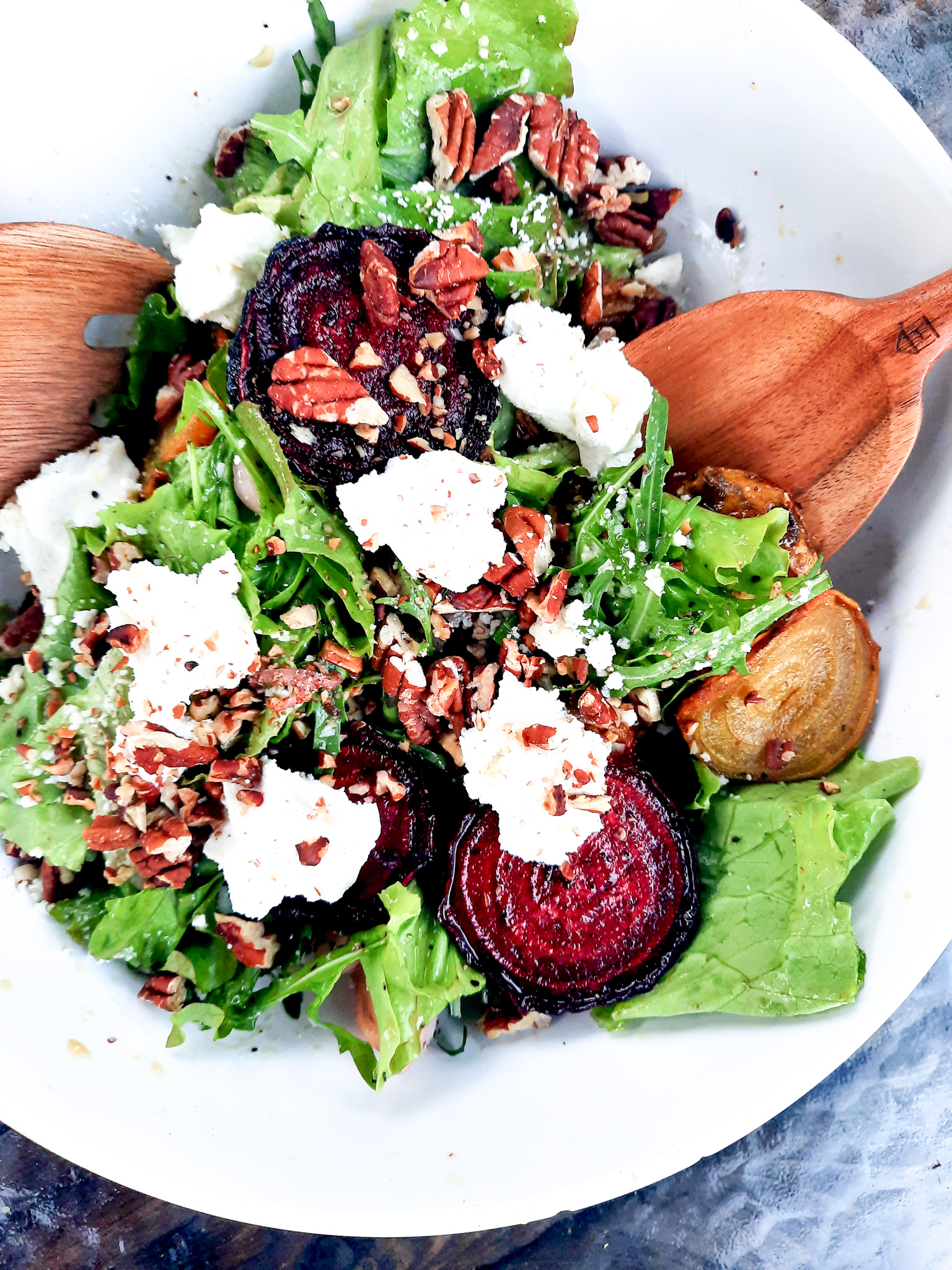 Roasted Beet Salad with Goat Cheese and Pecans combines slices of roasted red and yellow beets with goat cheese, greens and toasted pecans in a shallot vinaigrette.
