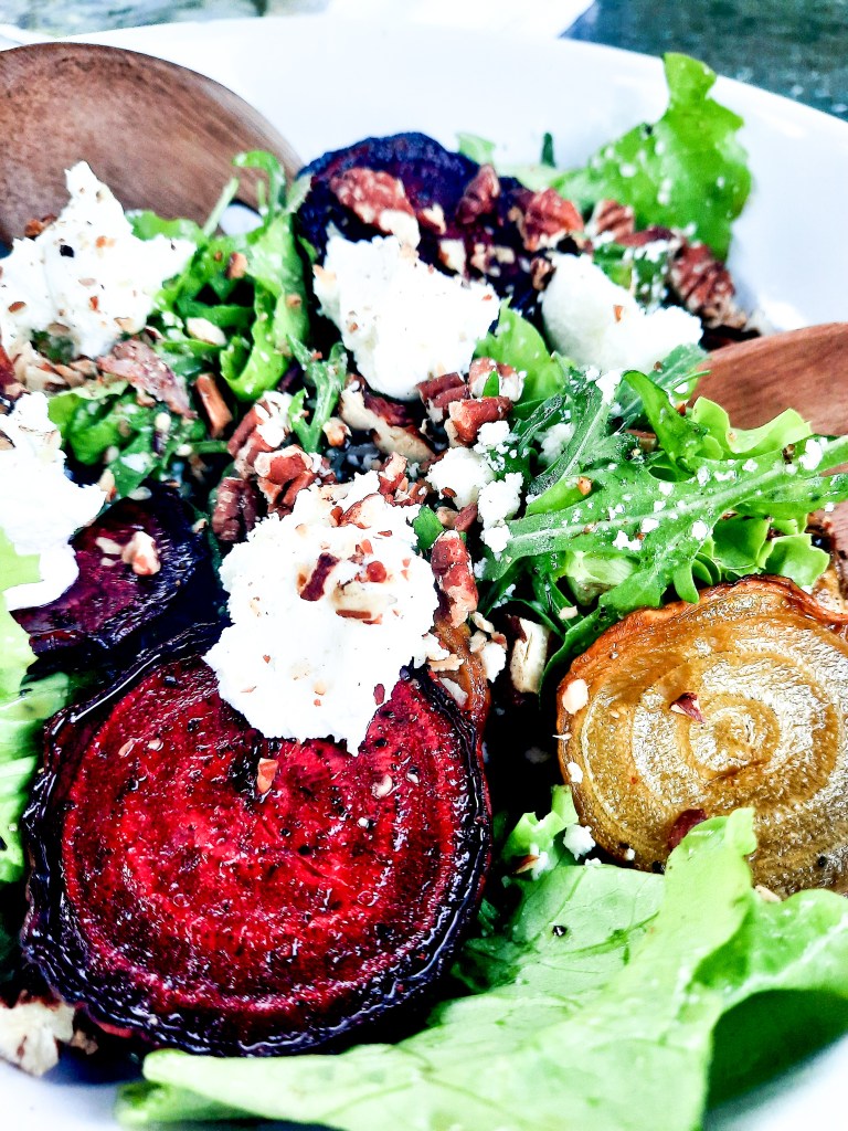 Roasted Beet Salad with Goat Cheese and Pecans combines slices of roasted red and yellow beets with goat cheese, greens and toasted pecans in a shallot vinaigrette.