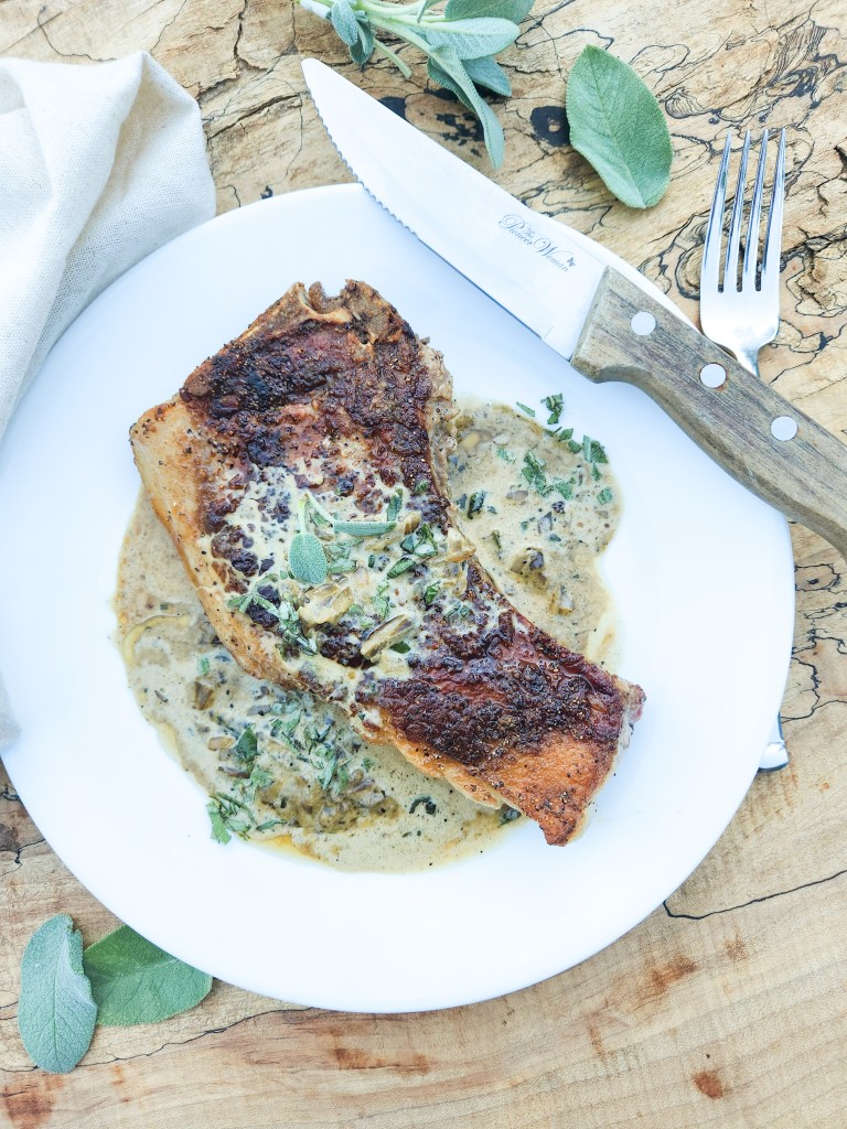 Pan Seared Pork Chops with Sage Cream Sauce utilizes a cast iron pan to created a juicy chop with a seasoned crust and a delicious pan sauce.