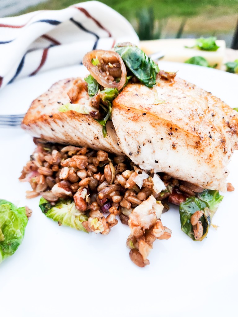 Halibut with Farro Salad comes together quickly with pan seared halibut and farro with brussels sprouts, pecans, parmesan and balsamic glaze.