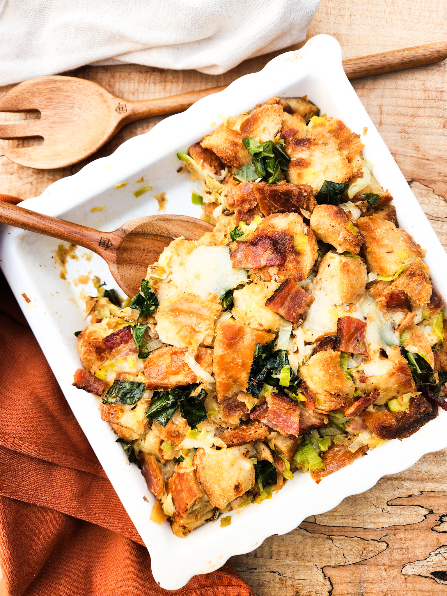 Sourdough Stuffing with Roasted Garlic is the most flavorful addition to your holiday table with bacon, greens and Swiss cheese.