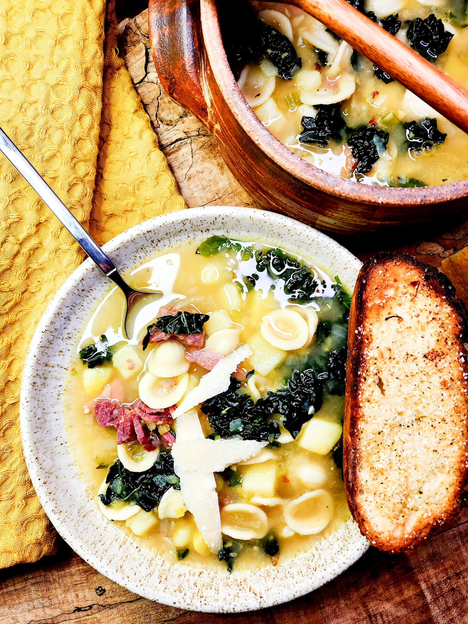 Orecchiette, Ham and Kale Soup with a flavorful bone broth, creamy diced potato, and plenty of shaved parmesan on top.