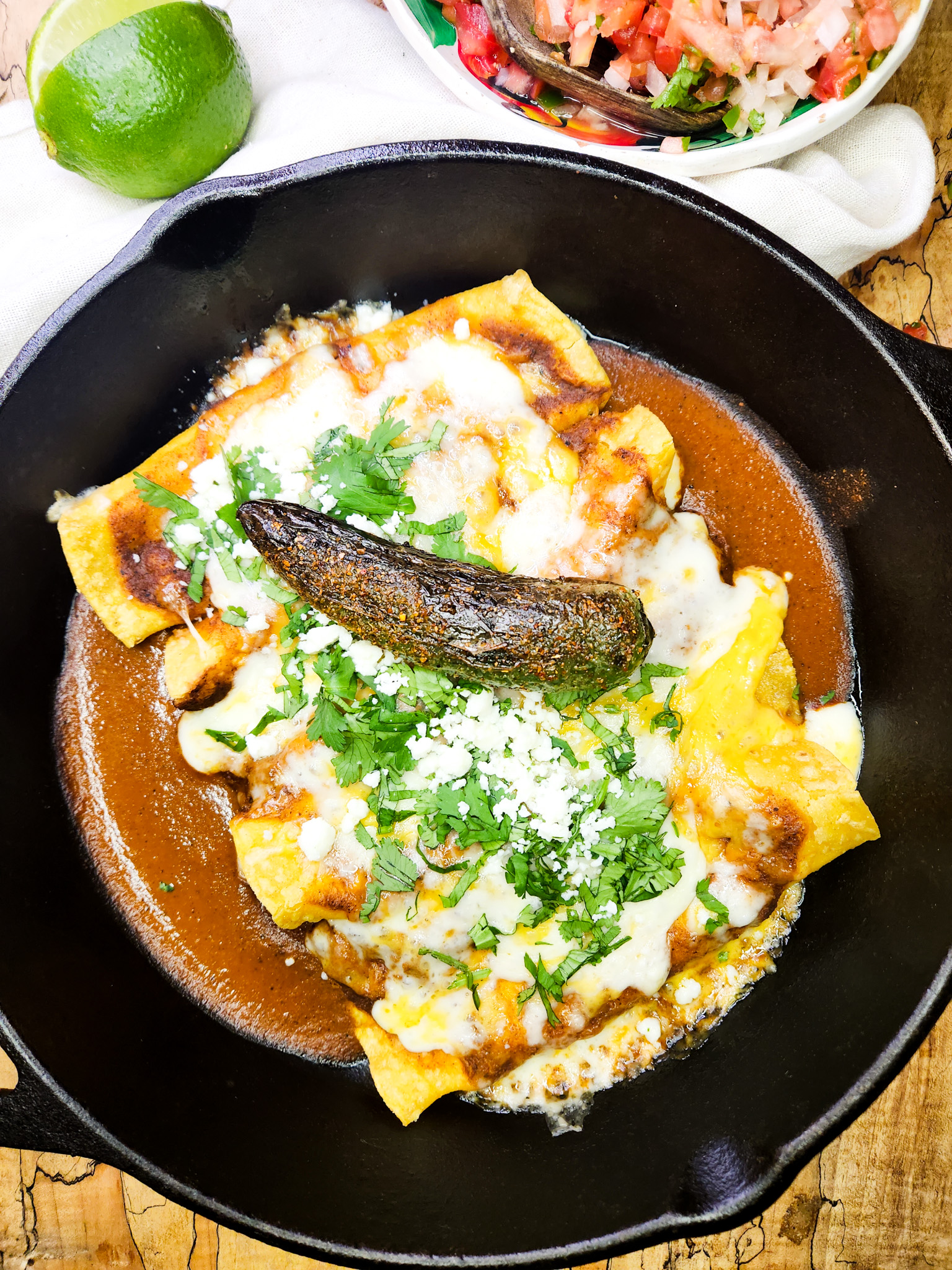 Chorizo and Jack Enmoladas are flavorful enchiladas coated in earthy mole sauce topped with Monterrey Jack cheese and baked until bubbly.