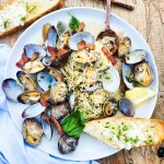 Manila Clams with Angel Hair in a light lemon garlic sauce with smoky pieces of bacon and fresh torn basil