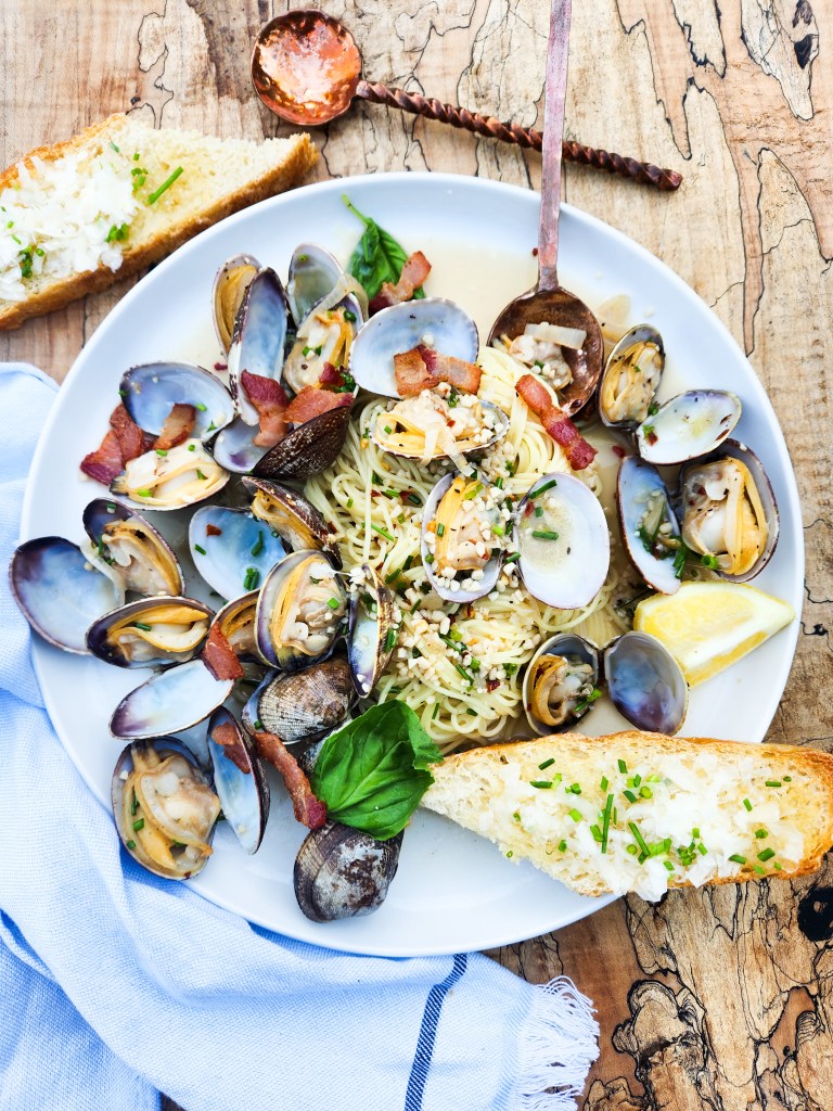 Manila Clams with Angel Hair in a light lemon garlic sauce with smoky pieces of bacon and fresh torn basil