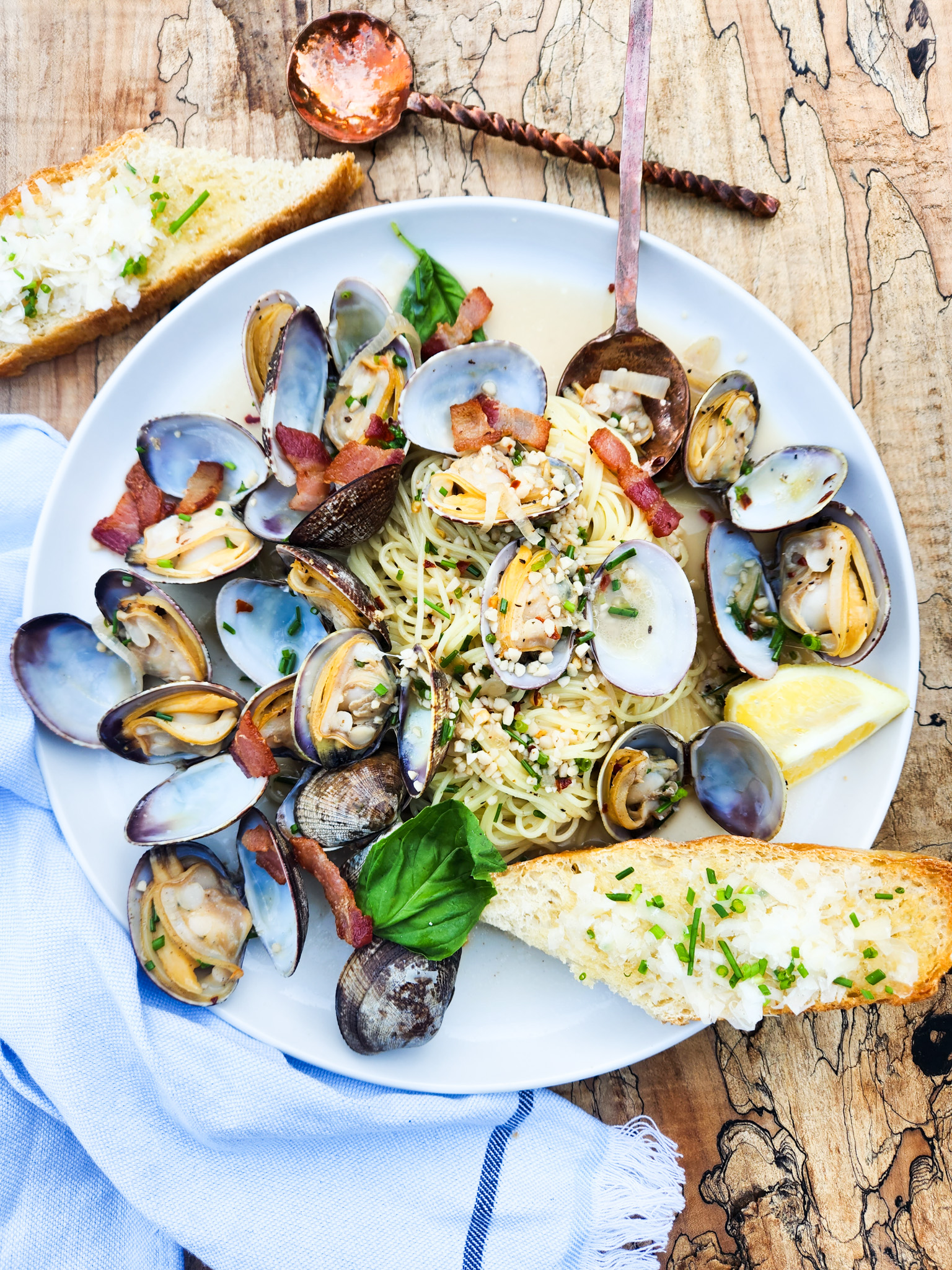 Manila Clams with Angel Hair in a light lemon garlic sauce with smoky pieces of bacon and fresh torn basil