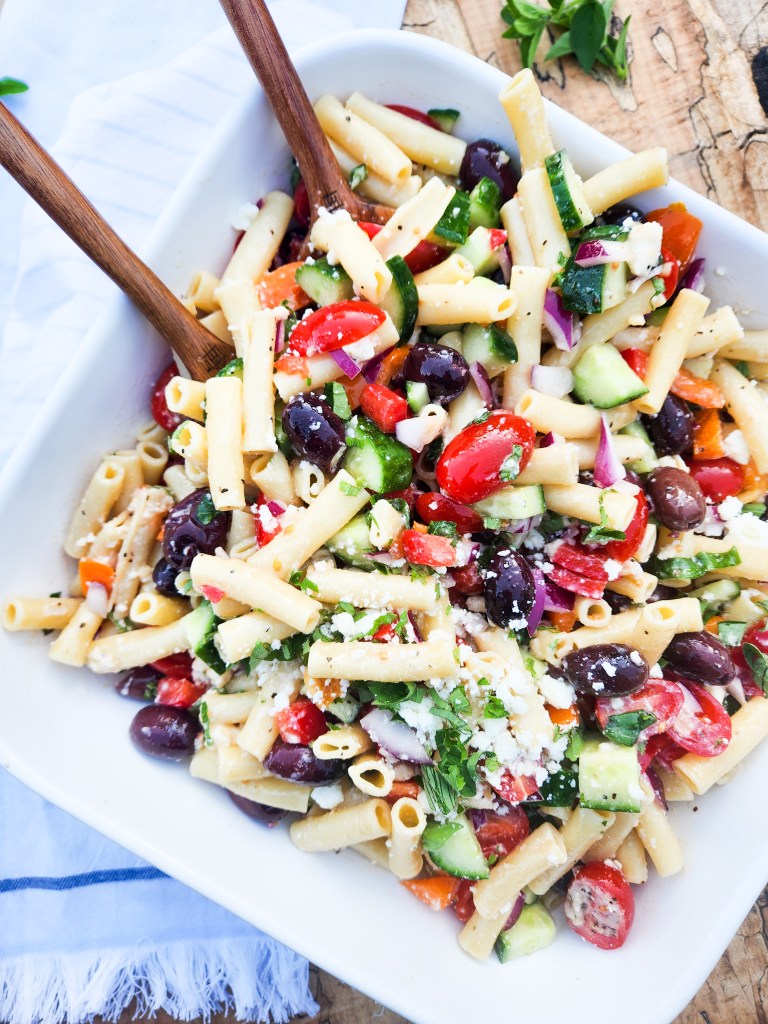 Greek Pasta Salad made with penne rigate and plenty of vinaigrette with cucumber, kalamata olives, bell pepper, grape tomatoes and feta.