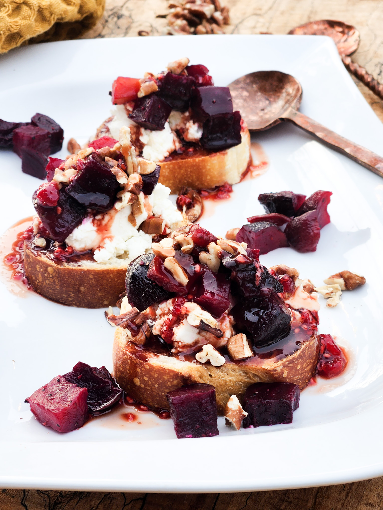 Creamy Smoked Beet Toast with goat cheese, toasted pecans and balsamic hot honey drizzle on sourdough toast.