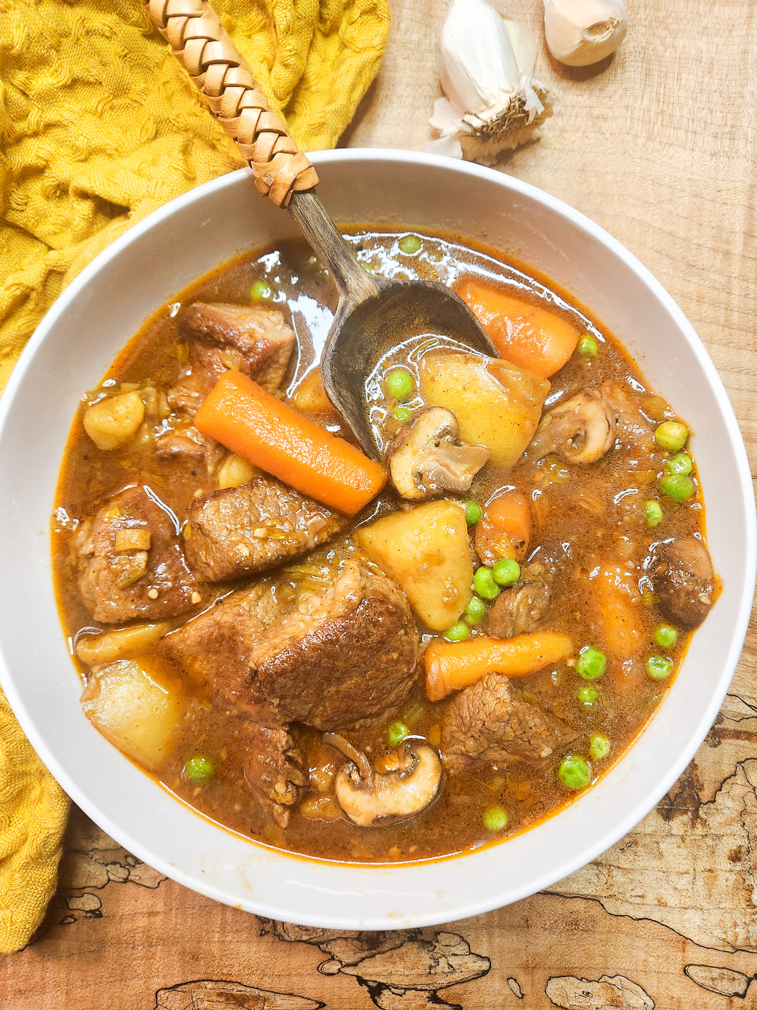Easy Weeknight Beef Stew quickly cooked with large pieces of tri-tip steak, creamy gold potatoes, carrots, mushrooms and peas.