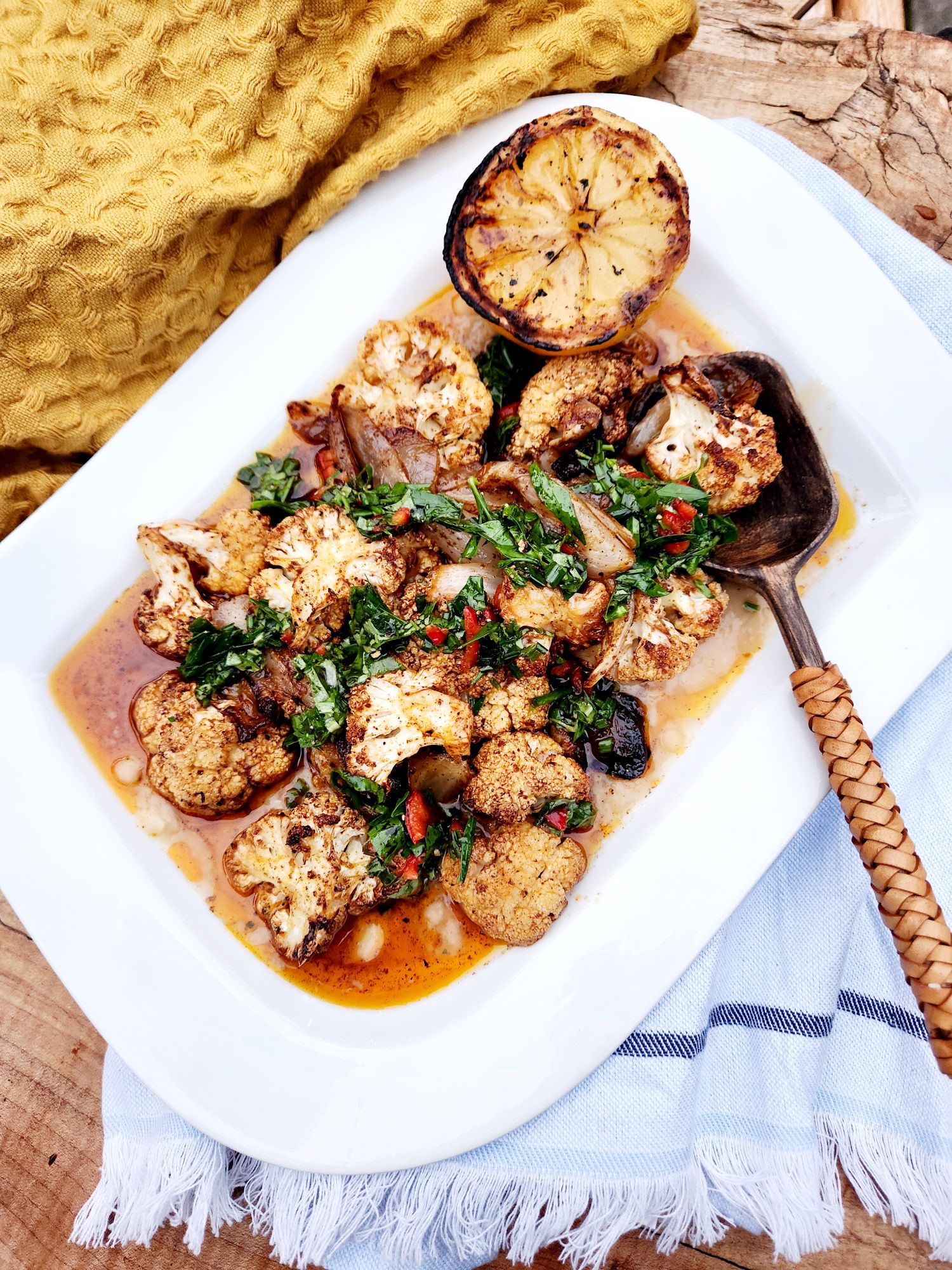 Moroccan Roasted Cauliflower over creamy white bean puree with chili herb gremolata and charred lemon.
