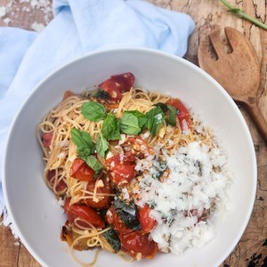 Blistered Tomato Basil Pasta with vine ripened cherry tomatoes, fresh basil and garlic in an olive oil sauce over angel hair pasta.