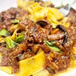Beef Short Rib Ragu is slow cooked for a rich, flavorful sauce of tender beef, tomatoes and mushrooms served over pappardelle pasta.