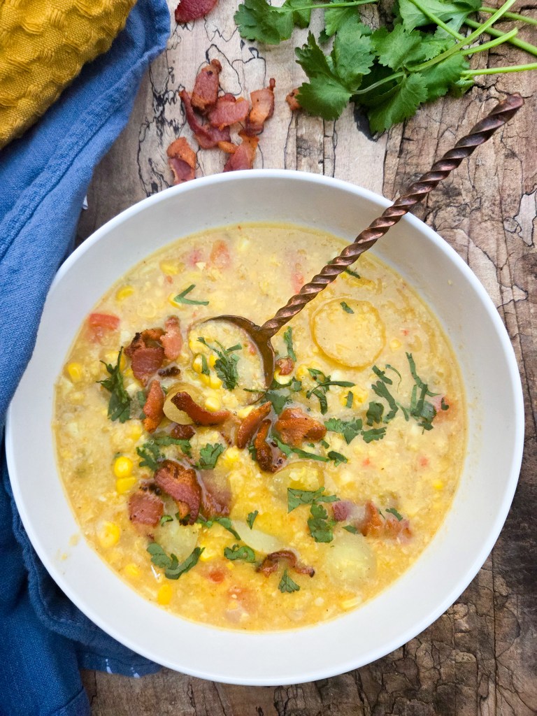 Corn chowder is creamy and bursting with bits of fresh corn, tender potatoes, cilantro and crispy bacon bits.