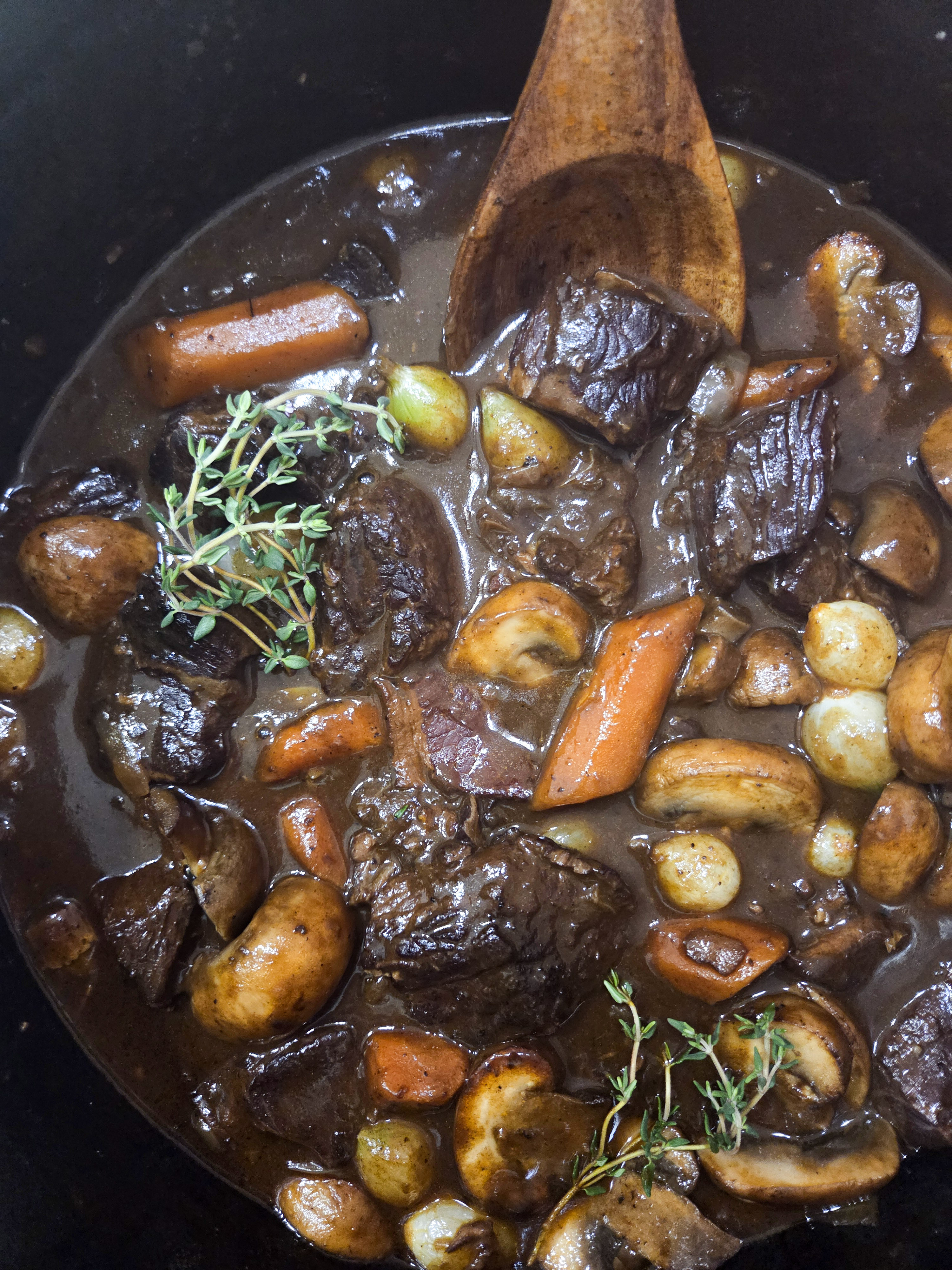 Beef Bourguignon is a classic made famous by Julia Child with seared and stewed beef, carrots, mushrooms and pearl onions in a red wine base.