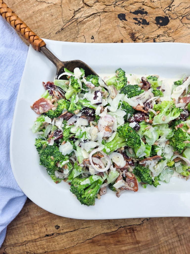 Modern Broccoli Salad is an updated version of the classic with shallots, bacon, cranberries, sunflower seeds and Pecorino cheese.