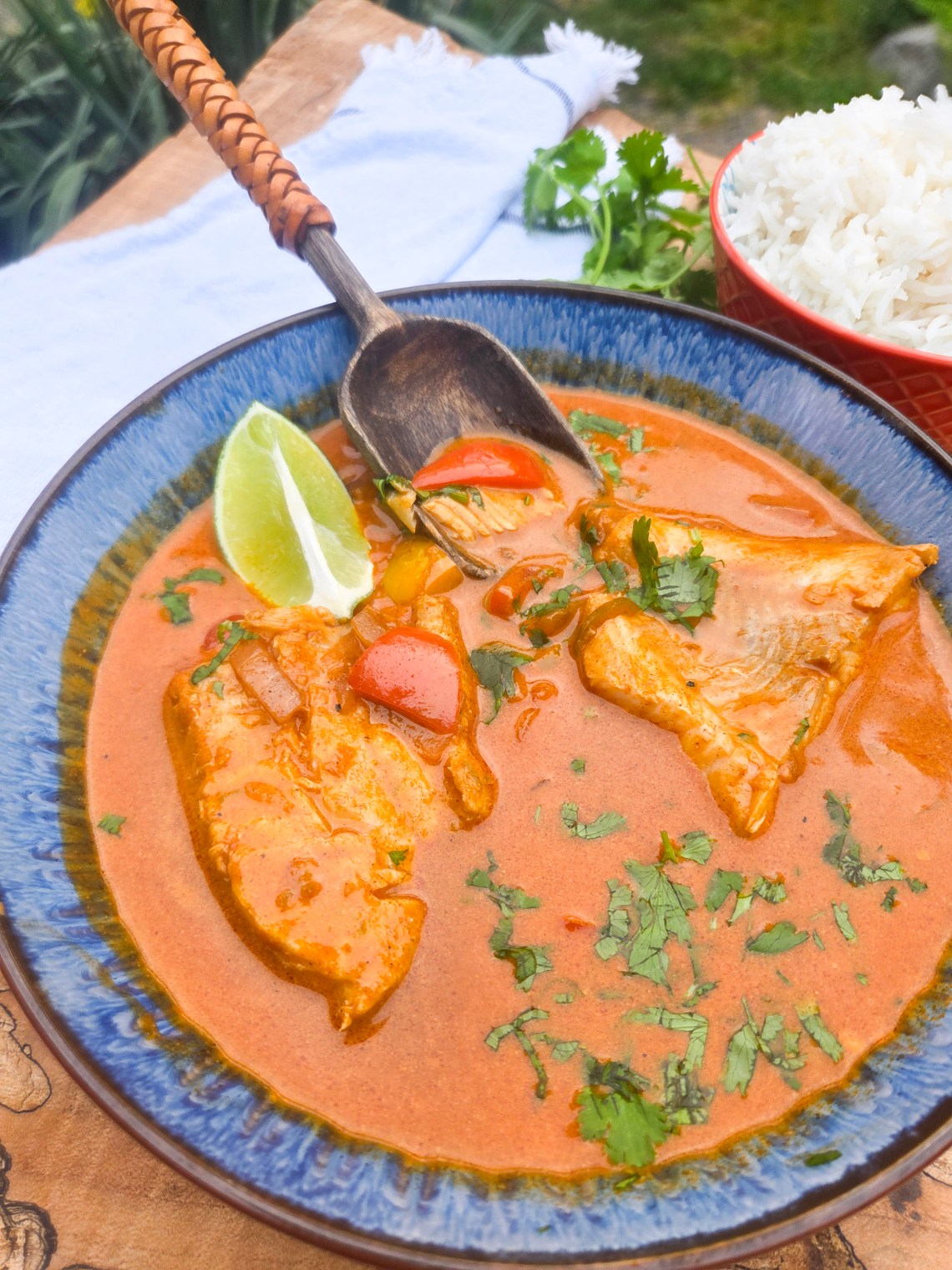 Brazilian Fish Stew with flakey cod poached in a flavorful spicy coconut tomato stew with red and yellow peppers and fresh lime.